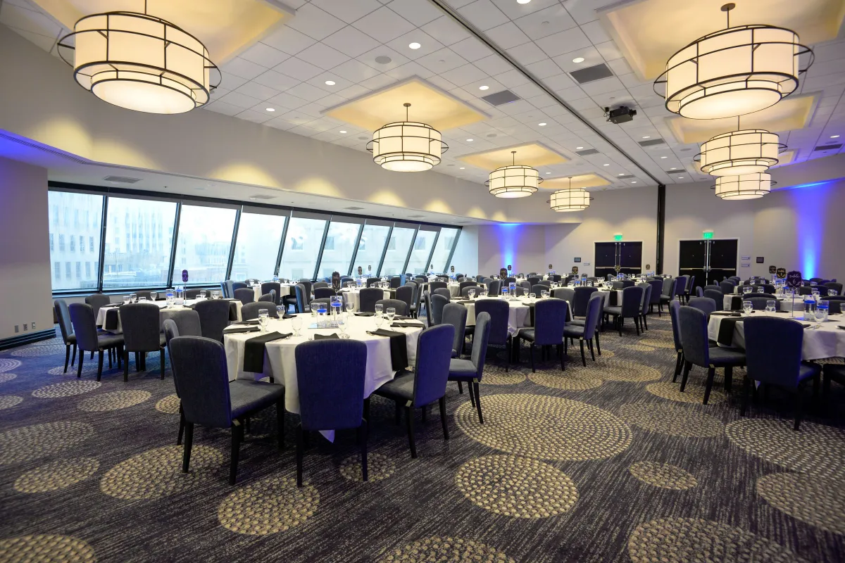 Banquet hall set with round tables for a corporate gala dinner