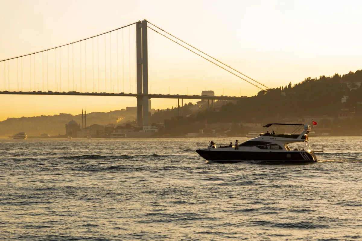 Private yacht on the Bosphorus at sunset with the Bosphorus Bridge behind